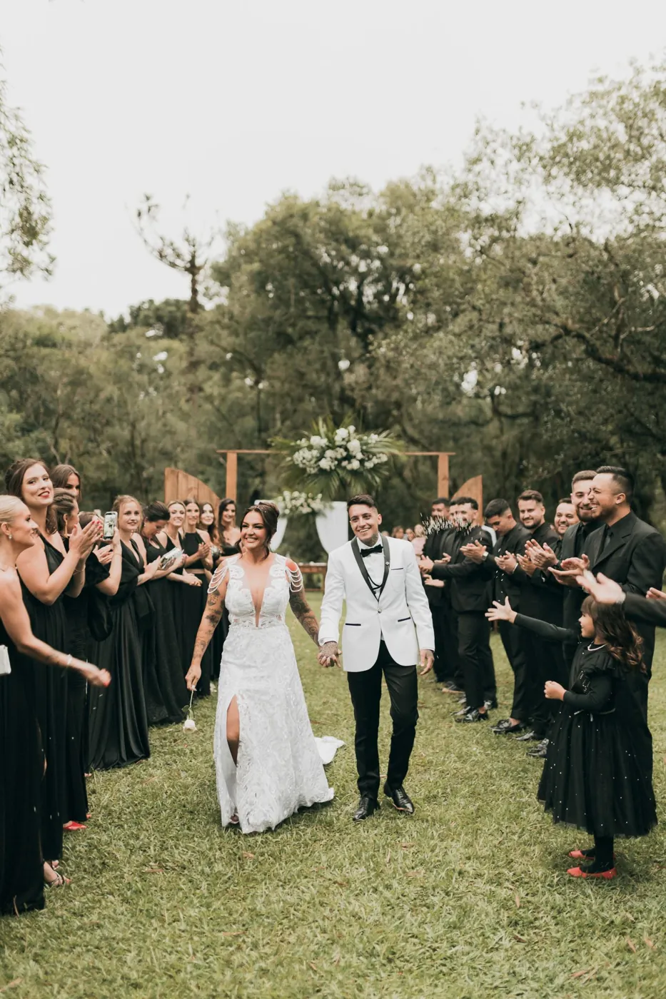 Guests cheering a couple down the aisle
